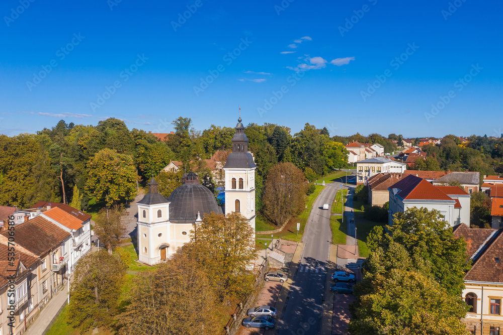 Croatia, Slavonia, town of Daruvar, catholic church in autumn, panoramic drone view