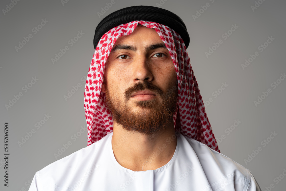 Portrait of young Arab man on gray background in studio Portrait of young Arab man on gray background in studio