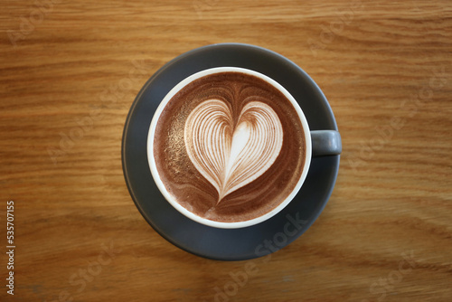 Latte art,Coffee mug placed on a table in a cafe.