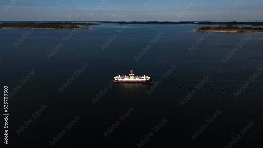 Aerial view away from a car ferry in the archipelago of Aland islands, Finland - pull back, drone shot Aerial view away from a car ferry in the archipelago of Aland islands, Finland - pull back, drone shot