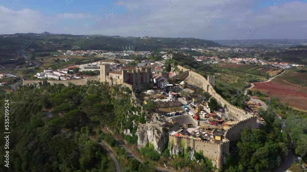 Aerial view around the Castelo de Óbidos fortress, in sunny Portugal - orbit, drone shot Aerial view around the Castelo de Óbidos fortress, in sunny Portugal - orbit, drone shot