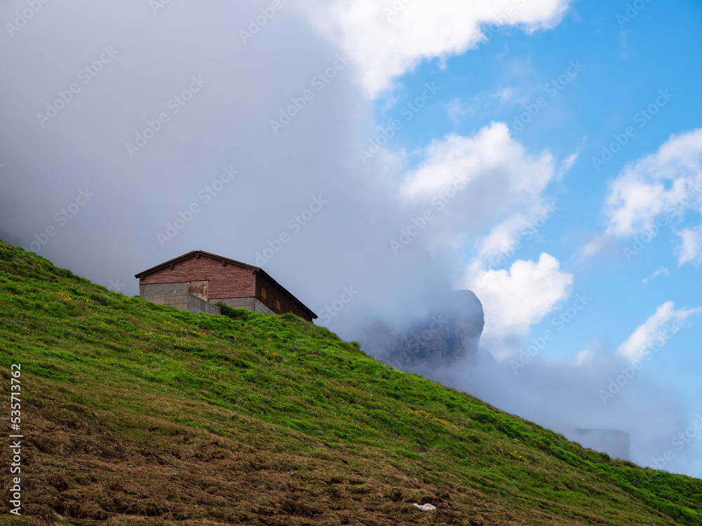 An autumn scene from Klausenpass in Switzerland - A dark cloud is beginning to cover the blue sky An autumn scene from Klausenpass in Switzerland - A dark cloud is beginning to cover the blue sky