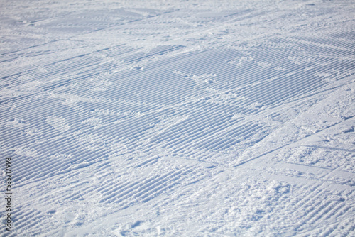 Snow on the ski run as background.