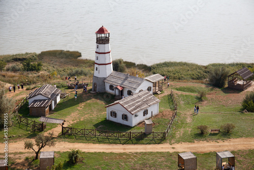 Merzhanovo, Russia: beautiful old lighthouse and wooden buildings on the sandy seashore of the Taganrog Bay, autumn, 2022. Set for the film 