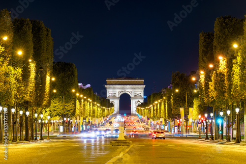 The Arc de Triomphe at night seen across des Champs-Élysées avenue in Paris, Francja photo