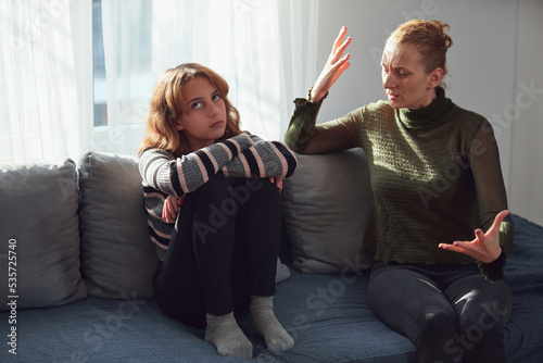 Teenage girl in difficult mood with angry mom.