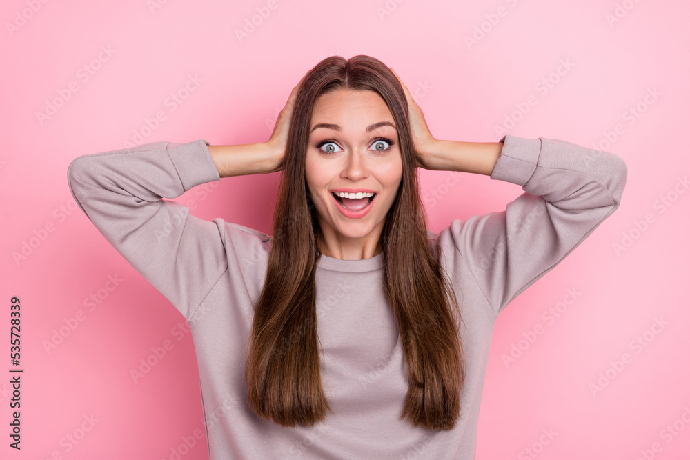 Portrait of astonished nice lady arms touch head toothy smile isolated on pink color background Portrait of astonished nice lady arms touch head toothy smile isolated on pink color background