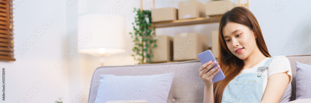 Online merchant concept, Female entrepreneur use smartphone and tablet to checking online orders Online merchant concept, Female entrepreneur use smartphone and tablet to checking online orders