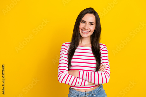 Photo portrait of stunning young girl folded arms confident manager leader wear stylish striped clothes isolated on yellow color background