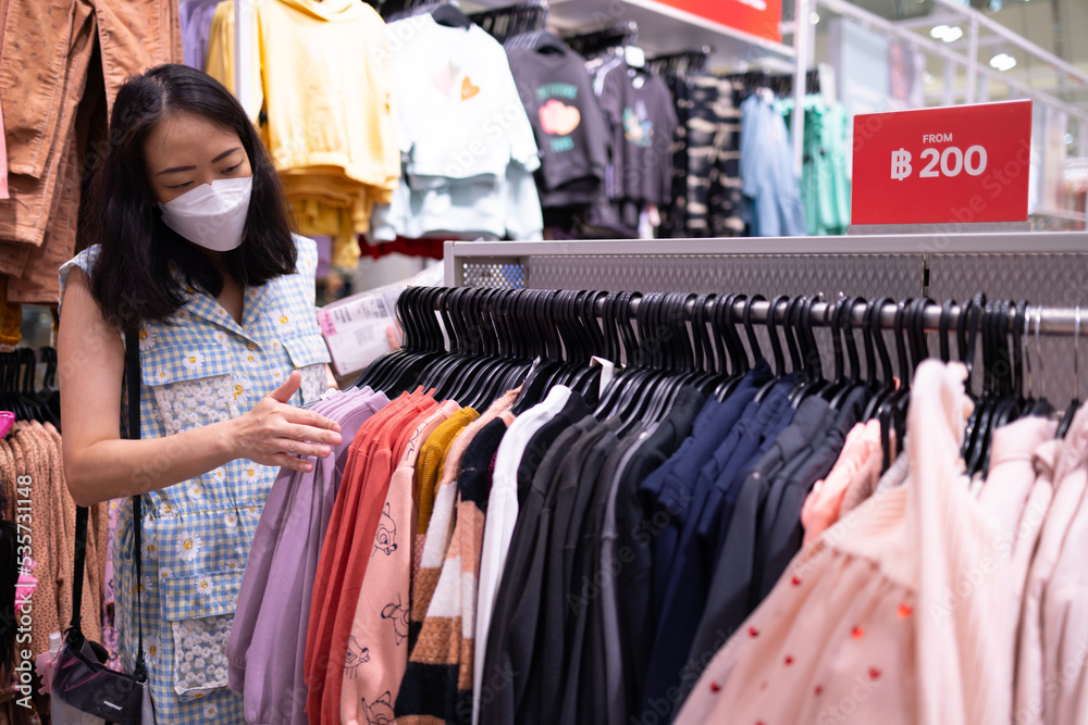Close up clothes hangers on rack with anti theft alarm. Background for fashion retail shop shop and apparel store. Close up clothes hangers on rack with anti theft alarm. Background for fashion retail shop shop and apparel store.