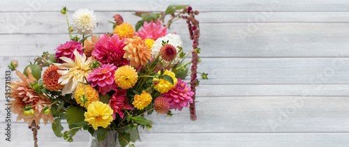  Kompozycja kwiatowa z kwiatów dalii, różowy bukiet na drewnianym tle jasnych desek photo