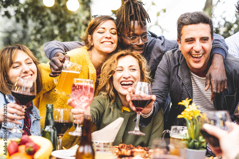 Group pf smiling friends drinking and toasting at private party, deverse people having fun outdoors, family reunion, happy hour Group pf smiling friends drinking and toasting at private party, deverse people having fun outdoors, family reunion, happy hour