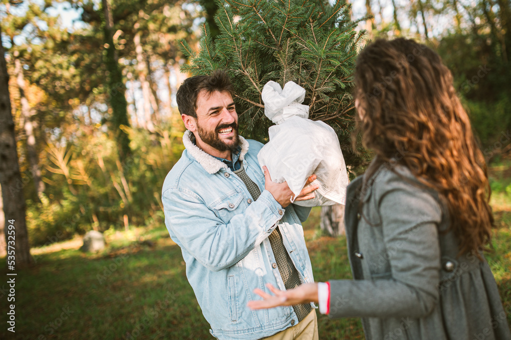 Young happy couple is preparing for the New Year holidays Young happy couple is preparing for the New Year holidays