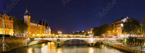 Pont au Change bridge near The Conciergerie palace and prison by the Seine river night  Paris. France