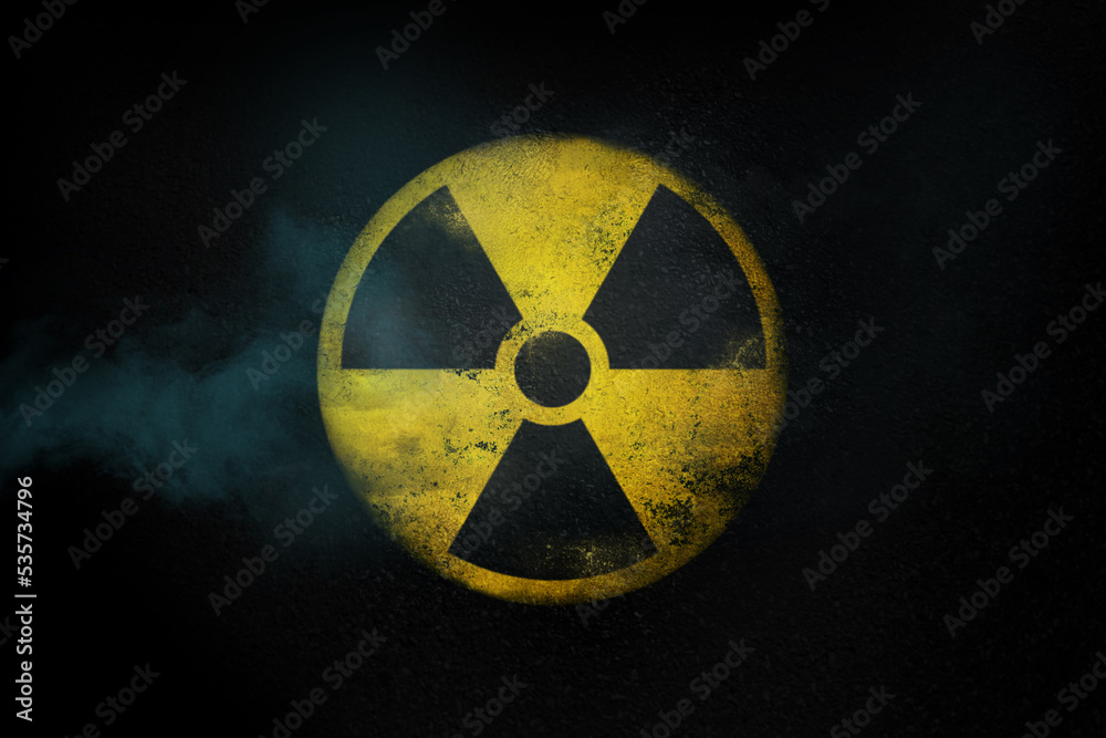 Nuclear energy radioactive round yellow symbol on asphalt texture - obrazy, fototapety, plakaty 