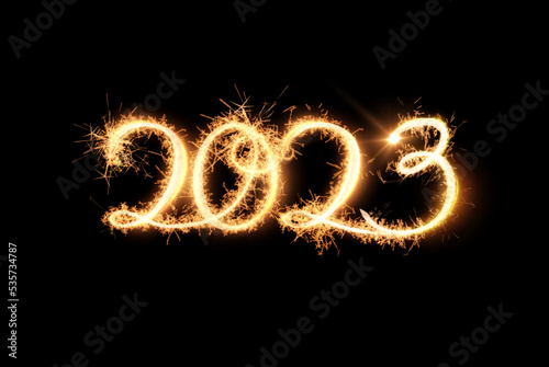 2023 holiday festive background light writing golden text on black backdrop. Hand written lettering with bright star.
