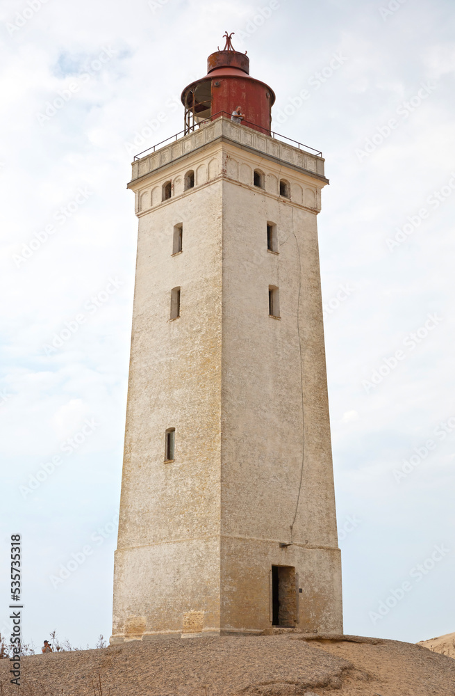Lokken, Denmark - August 24, 2022: People at the popular Rubjerg Knude Lighthouse in Jutland.