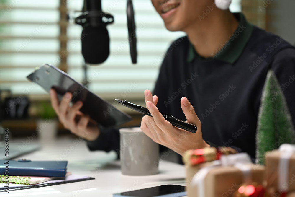 Image of radio host using microphone and laptop to recording podcast in home studio. Radio, podcasts and technology concept Image of radio host using microphone and laptop to recording podcast in home studio. Radio, podcasts and technology concept