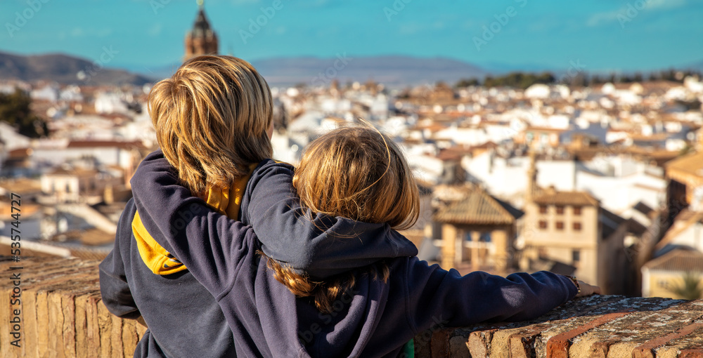 Two brothers looking at urban panorama view ( Antequera in Spain)