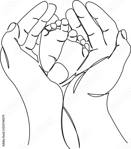 newborn's feet in hands