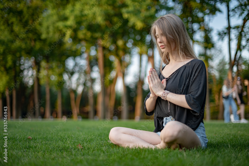 Girl practice yoga meditation outdoor in park Girl practice yoga meditation outdoor in park