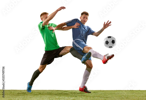 Soccer football players tackling for the ball on grass flooring over white background. Concept of sport, action, competition, football match © master1305