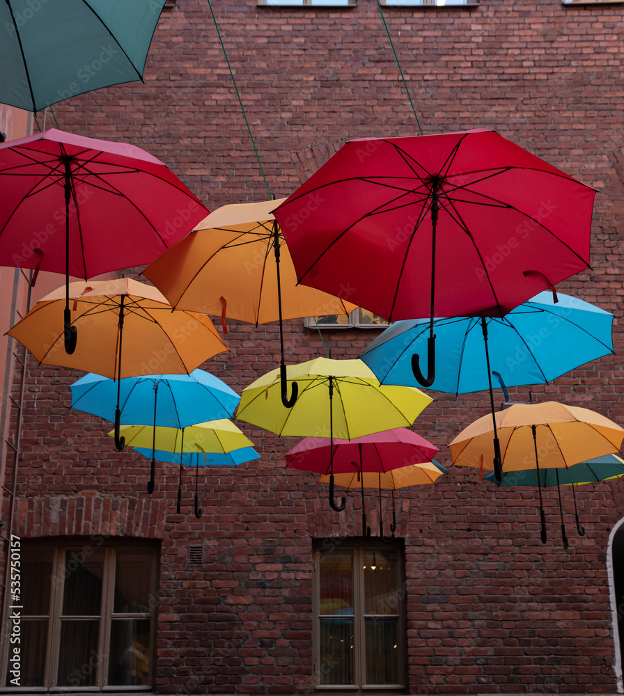colorful umbrellas on the background of a brick wall