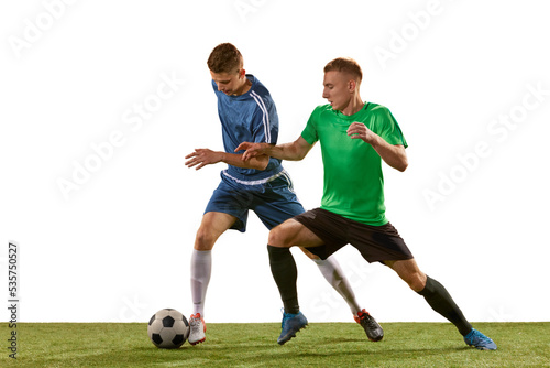 Soccer football players tackling for the ball on grass flooring over white background. Concept of sport, action, competition, football match © master1305