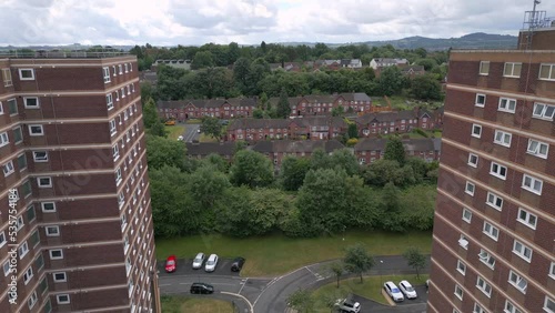 Aerial reveal of an English residential area with tower blocks of flats