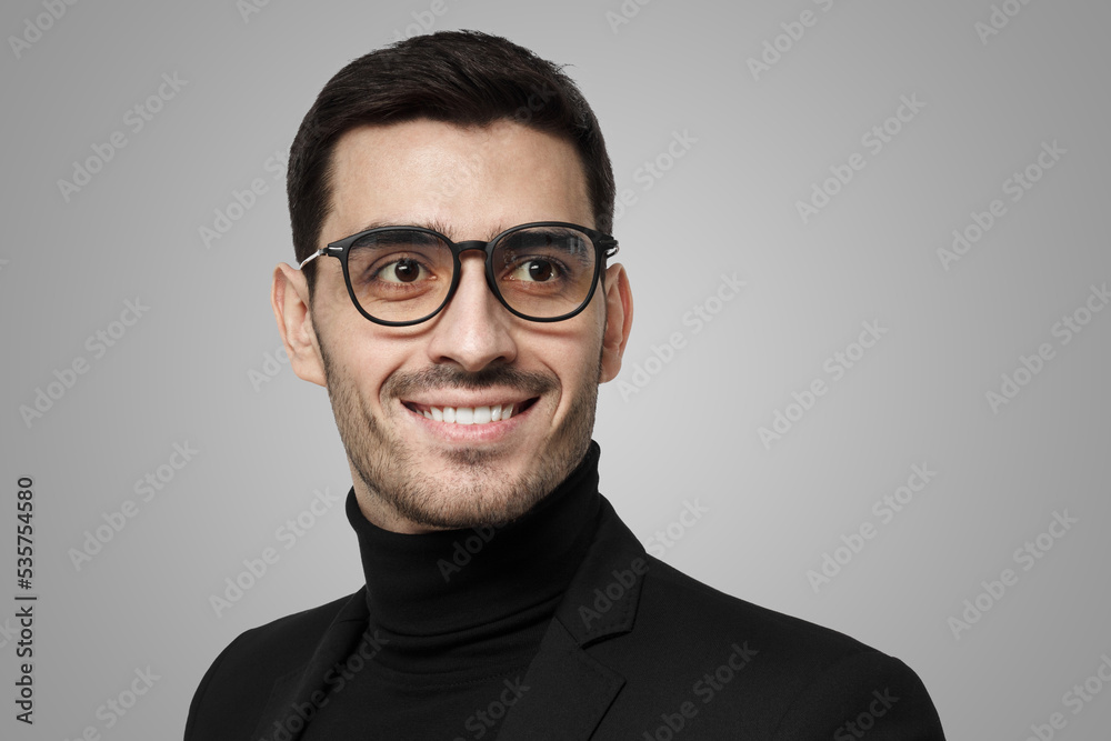 Fototapeta premium Man in black with glasses looking aside as if staying in thoughts and ideas, seeking for solution