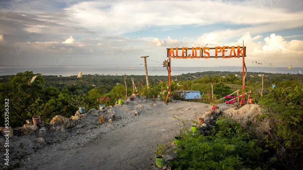 Fototapeta premium Scenic view of Alejo's Peak park with a sign in Bogo, Cebu, Philippines