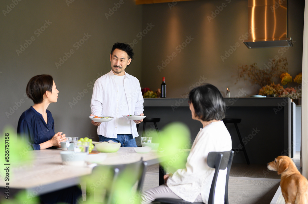 Husband serving food in dining room Living together/two-generation family Living with dog Husband serving food in dining room Living together/two-generation family Living with dog