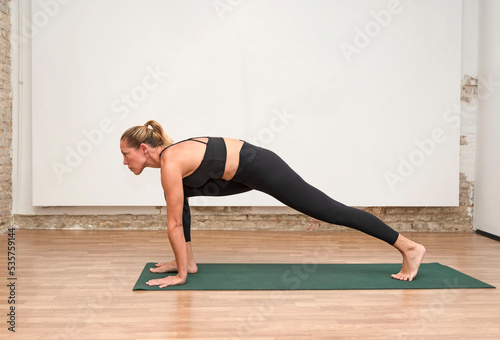 a young woman practicing yoga stretching, low lunge pose
