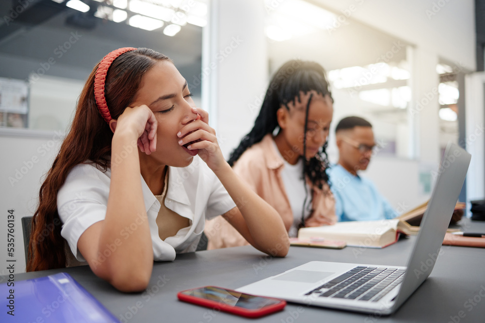 Burnout, tired and university student study in class lecture or library with laptop learning or digital education scholarship application or research. Fatigue, yawn and gen z woman college technology