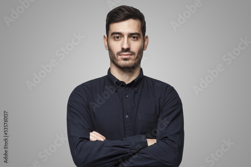 Portrait of confident businessman on gray background