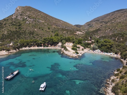 Aerial view of Cala Moresca and Figarolo Island in Golfo Aranci, north Sardinia. Birds eye from above of yacht, boats, crystalline and turquoise water. Tavolara Island in the background, Sardegna. photo