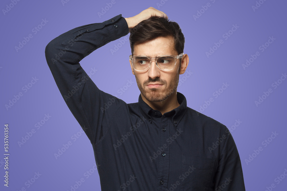 Pensive businessman thinking, scratching his head trying to find solution