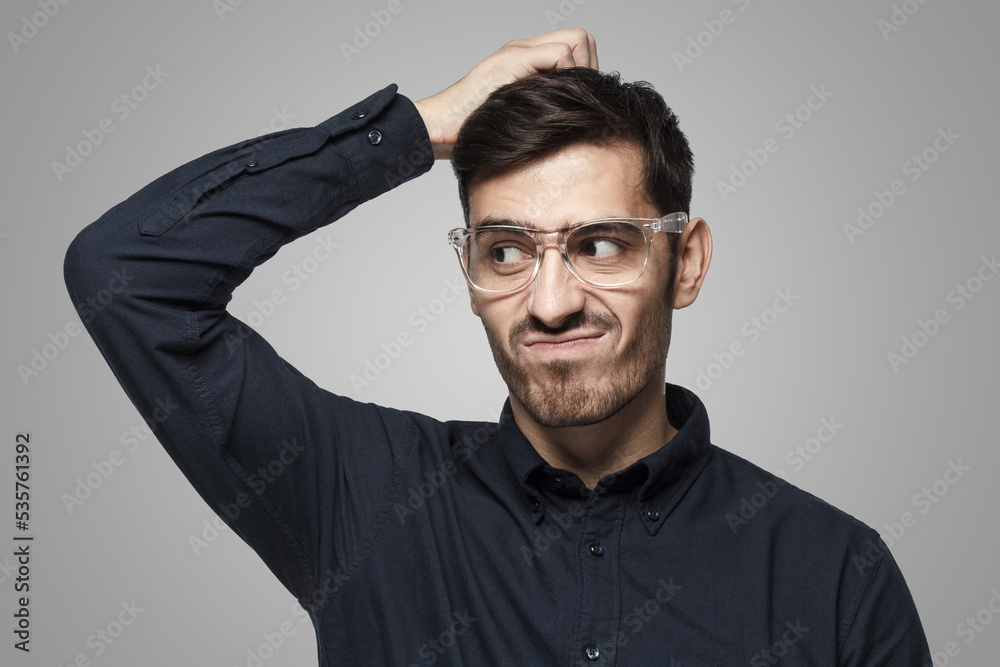 Thoughtful business man thinking, scratching his head trying to find solution Thoughtful business man thinking, scratching his head trying to find solution