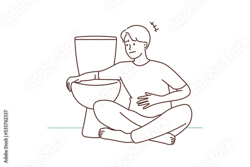 Unhealthy man feeling nauseous near toilet 