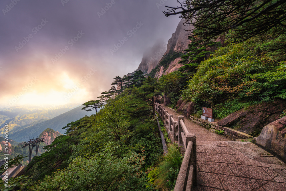 Lonely mountain pathway at Mount Huangshan during a misty sunset