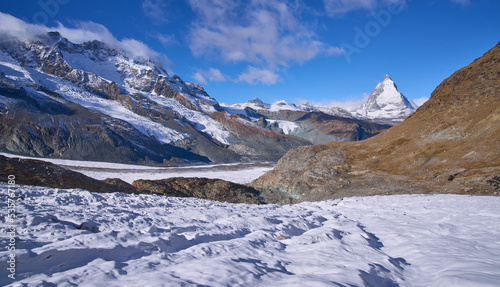 Panoramic view on the iconic mount Matterhorn at background and the Border glacier Grenz Gletscher at foreground in a sunny autumn day, seen from a trail to Monte Rosa hut. © A.Pushkin