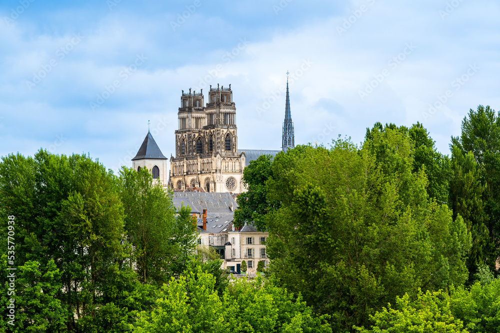 Orleans, Loire Valley area, France: Skyline of the city of Orleans with the Cathedral of the Holy Cross of Orleans beyound green trees, a UNESCO world heritage site
