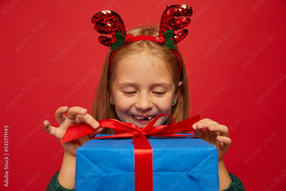Smiling funny child (kid, girl) in Reindeer Hairband Smiling funny child (kid, girl) in Reindeer Hairband
