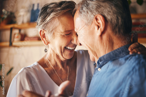 Dancing, happy senior couple smile together and dance with love in retirement. Anniversary celebration at home, mature married healthy man and active woman support each other in retired old age