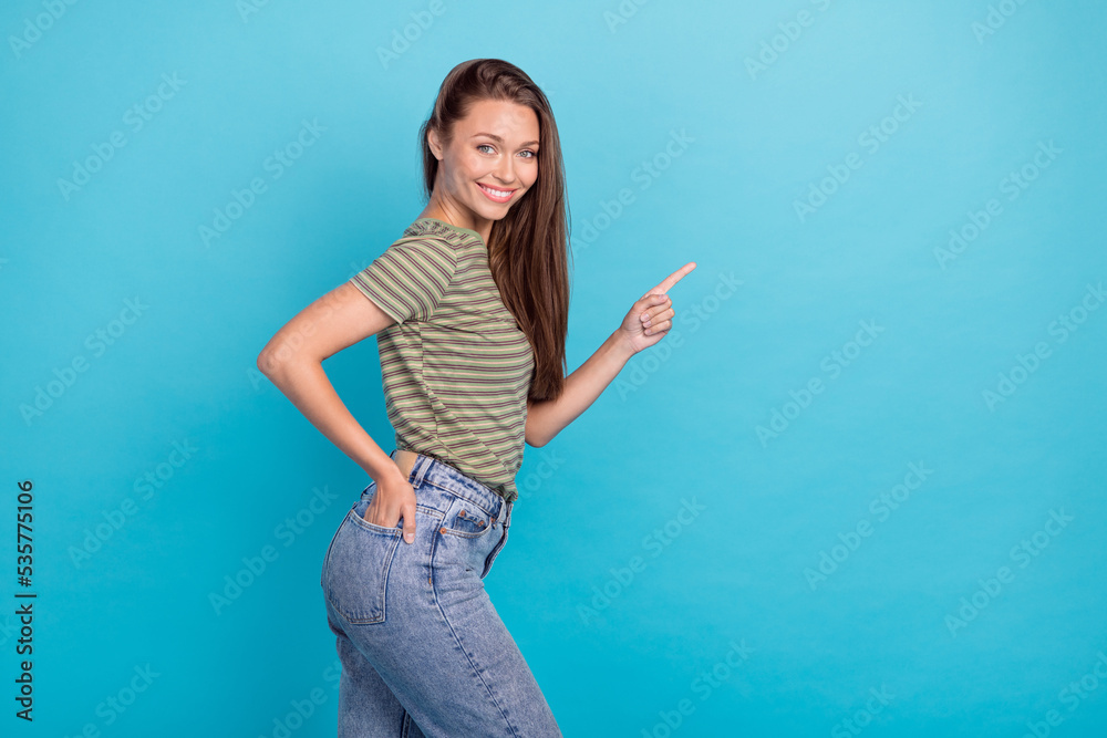Photo of satisfied cute lady dressed stylish striped outfit arm direct empty space hot proposition low price isolated on blue background Photo of satisfied cute lady dressed stylish striped outfit arm direct empty space hot proposition low price isolated on blue background
