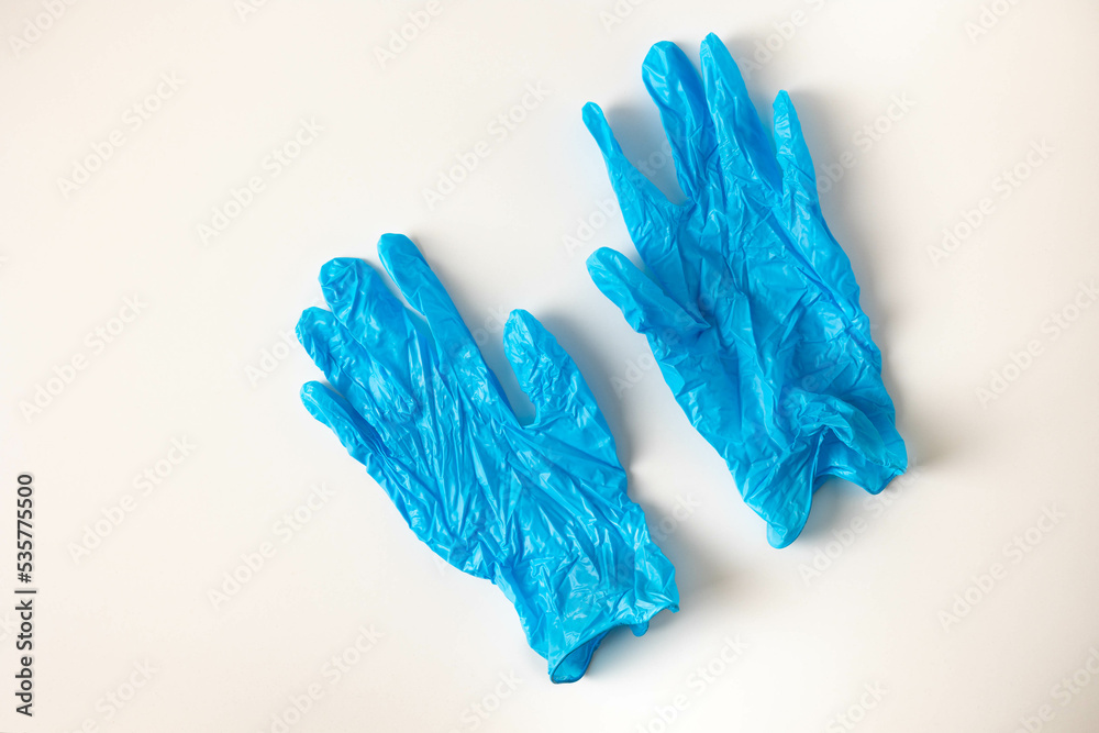 Blue medical gloves on a white background.