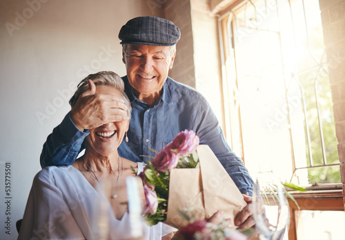 Photography Love, flowers and surprise gift with elderly couple in celebration of a birthday or anniversary, happy and romantic