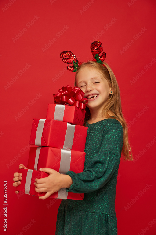 Smiling funny child (kid, girl) in Reindeer Hairband