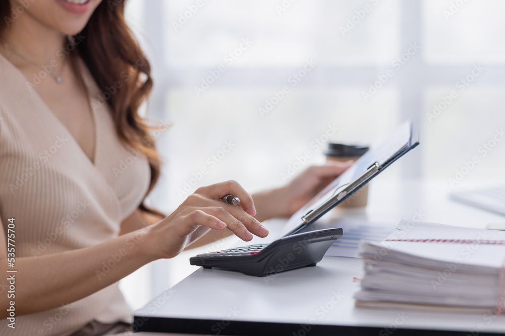 Asian businesswoman Accounting using calculating income-expenditure and analyzing real estate investment data report Financial and tax systems concept. Asian businesswoman Accounting using calculating income-expenditure and analyzing real estate investment data report Financial and tax systems concept.