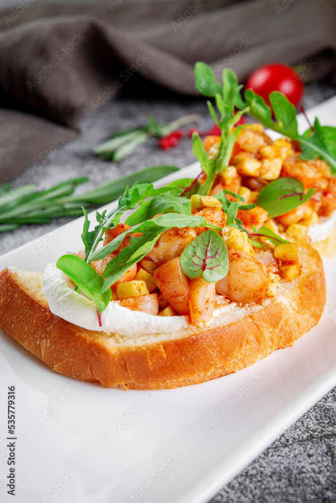 Delicious snacks. Toasted croutons with squid. Bruschetta with seafood and lettuce Delicious snacks. Toasted croutons with squid. Bruschetta with seafood and lettuce